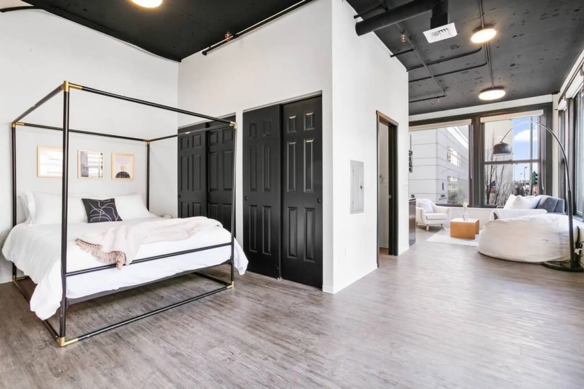 Bedroom with a queen bed and white linens.