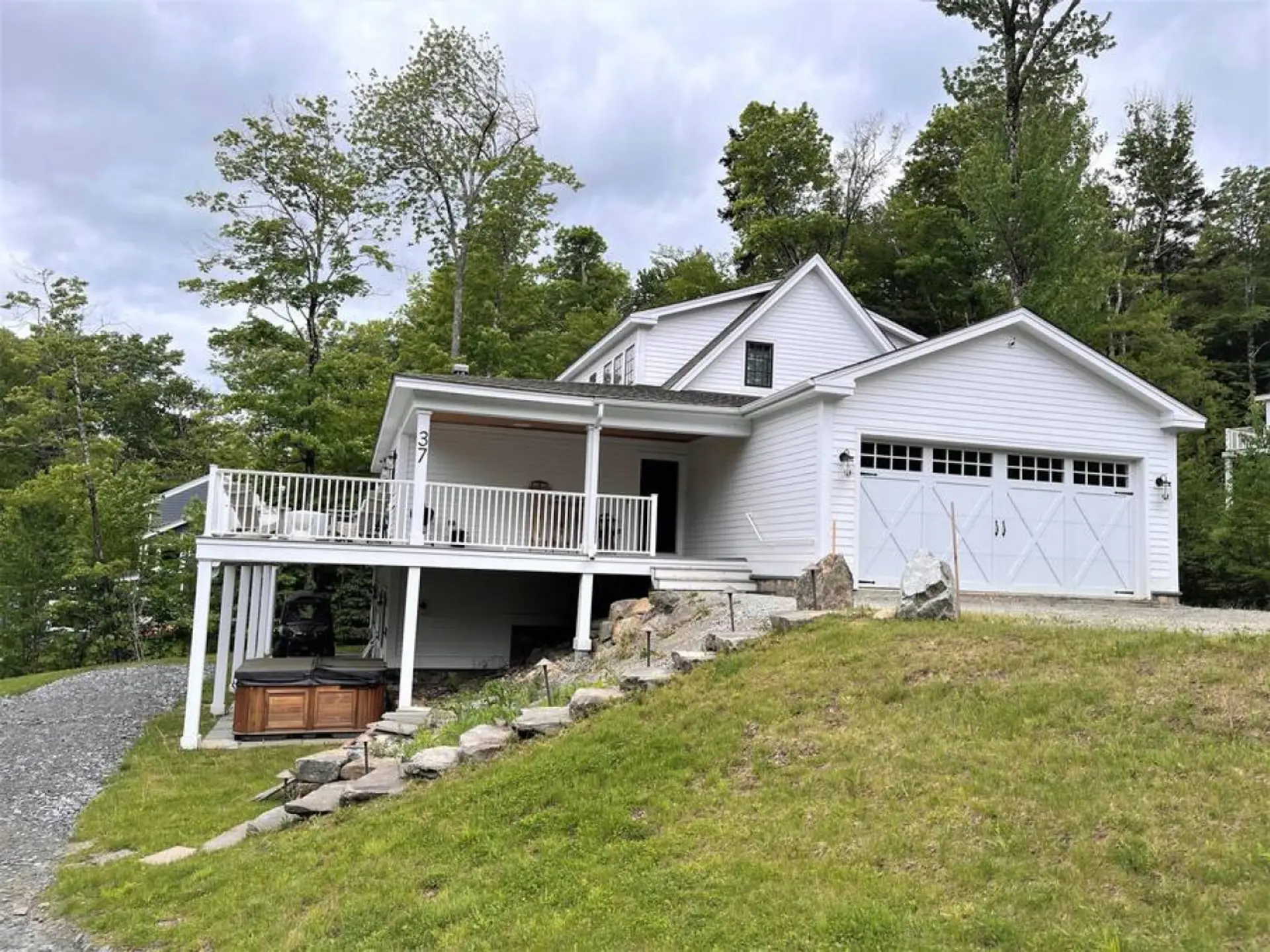 Large deck for entertaining on top level and lower level covered Hot tub area