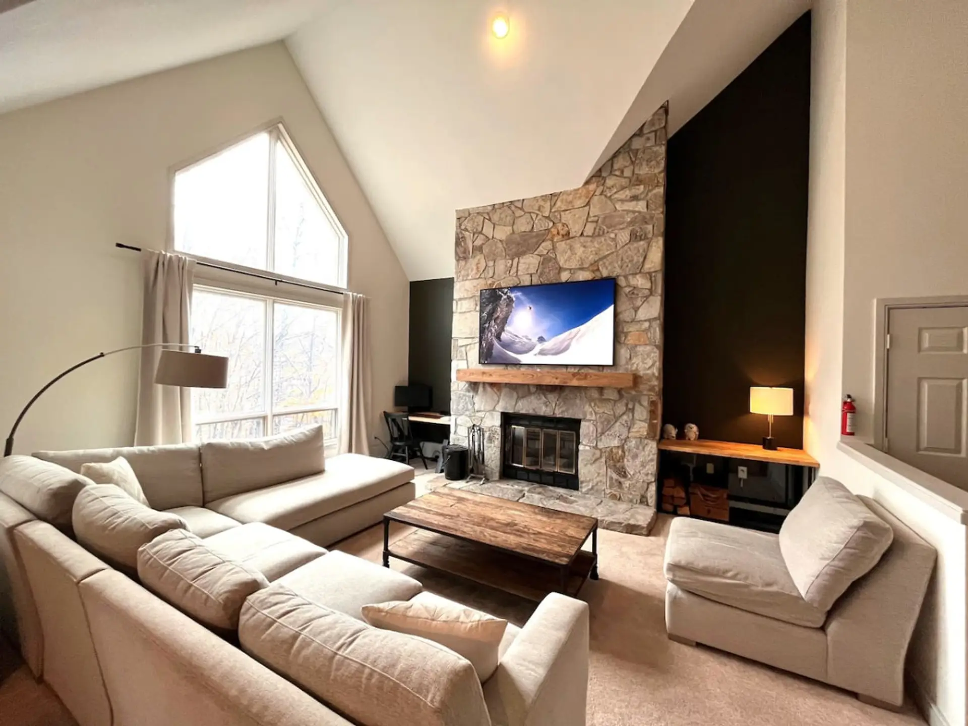 Open concept living area with huge couch and 65" Smart TV