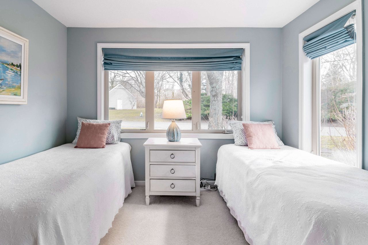 Two twin beds with attached full bathroom and a walk-in closet