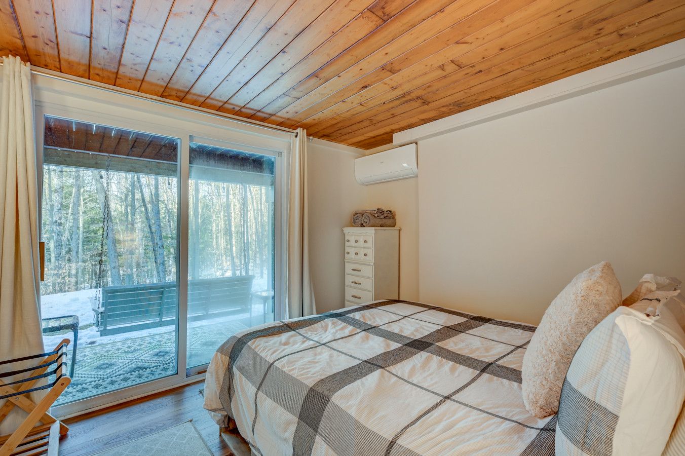 Another queen bed with luxurious linens, AC, and a slider out to the yard