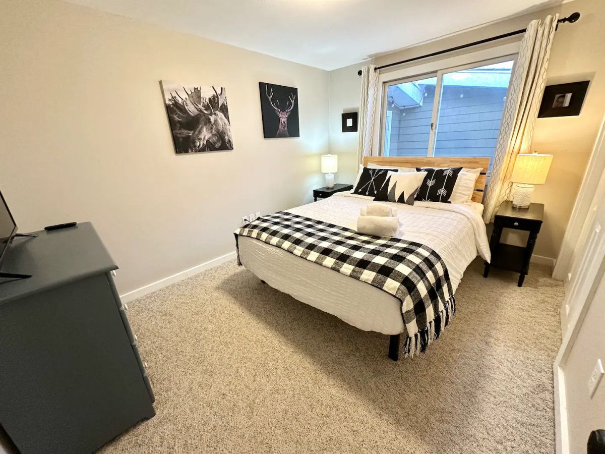 Our second bedroom with a queen sized bed, TV and a full bathroom across the hall located on the main floor