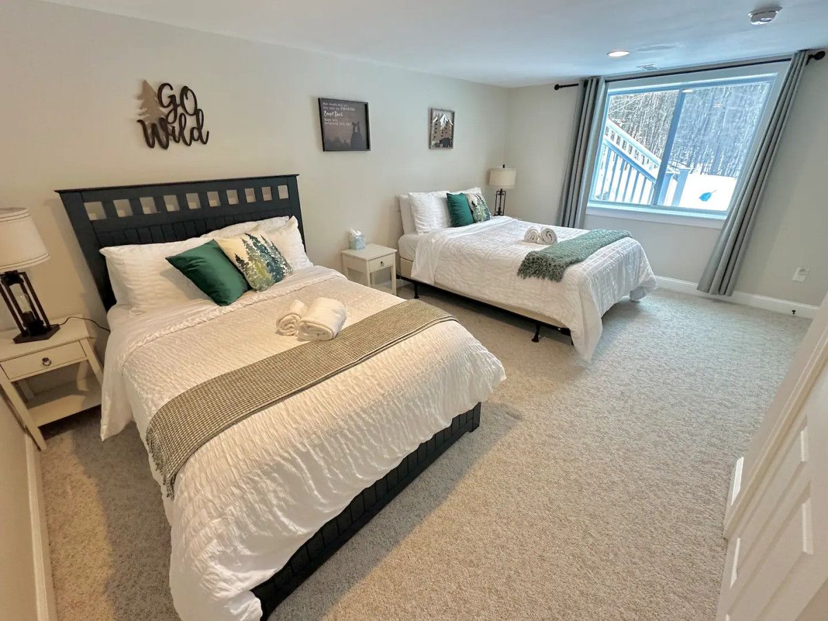 Our fourth bedroom, downstairs, with a queen bed and a full bed. There is a full bathroom down the hall.