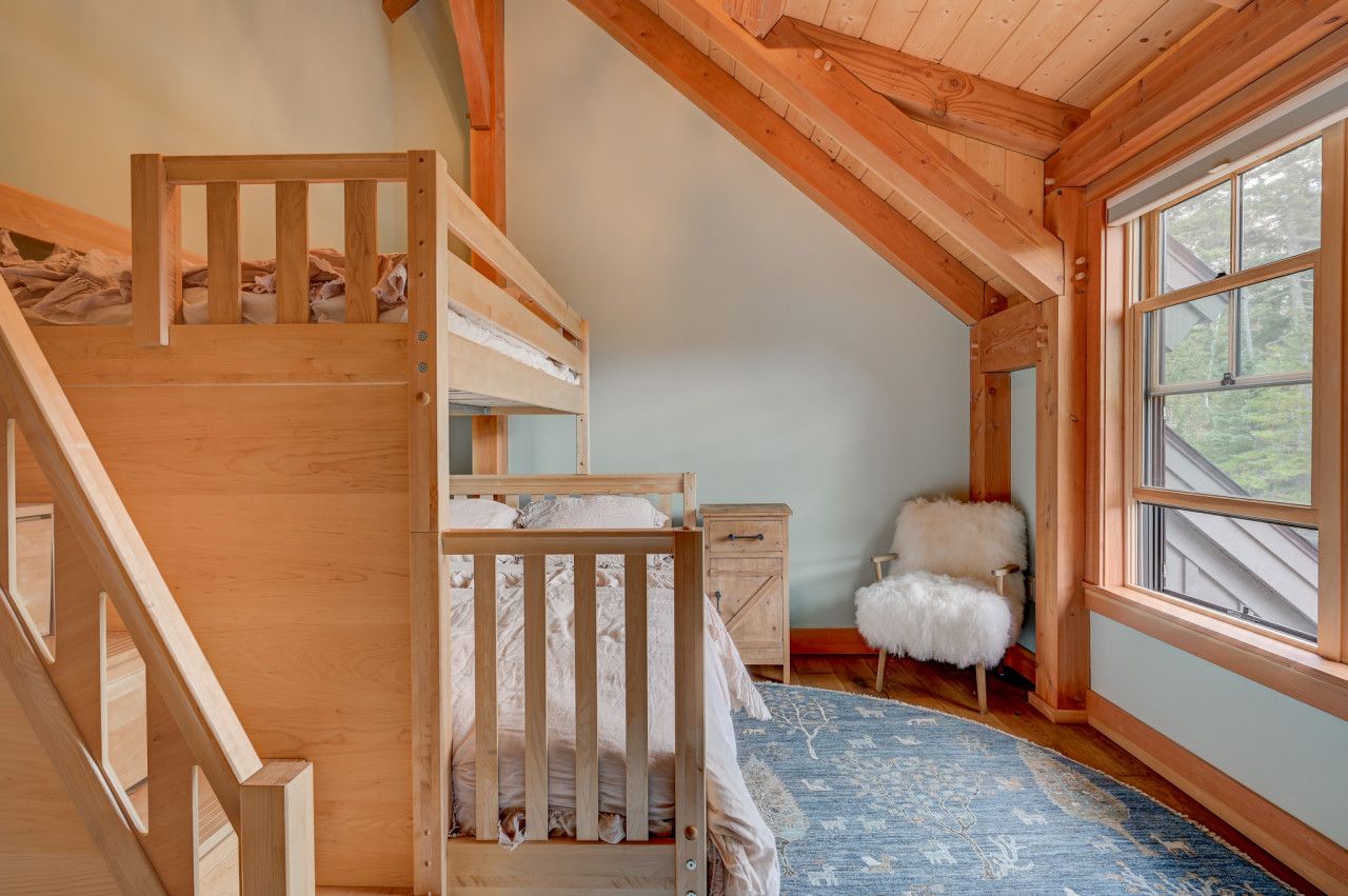 Cozy upstairs bedroom featuring a twin-over-queen bunk bed, perfect for kids or extra guests.