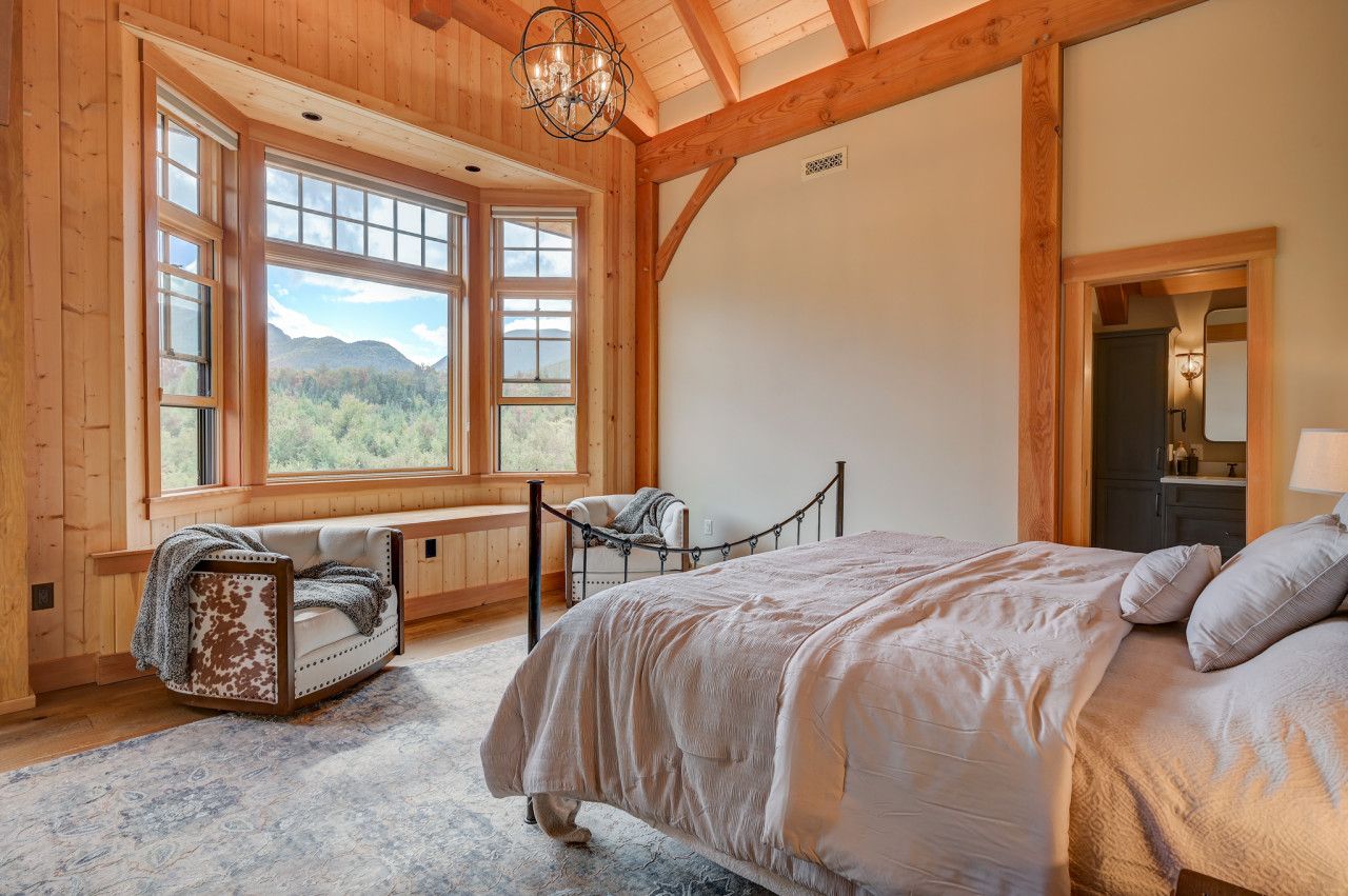 Luxurious master suite with a king-sized bed, ensuite bathroom, and breathtaking mountain views.