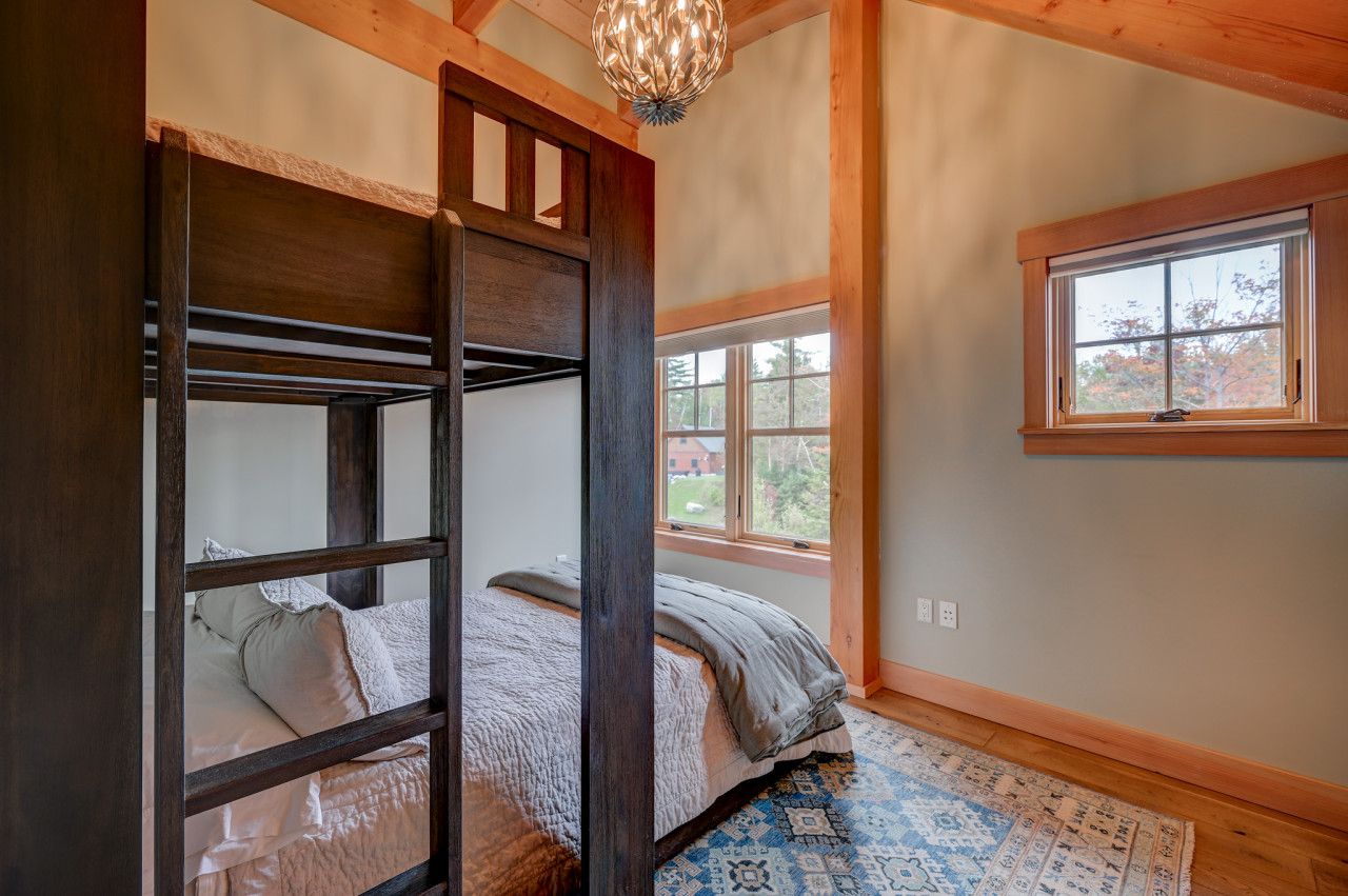Cozy upstairs bedroom featuring a twin-over-queen bunk bed, perfect for kids or extra guests.