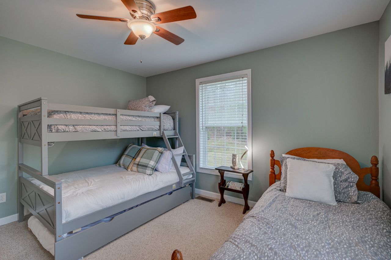 Fun and functional 4th bedroom on the main floor—perfect for kids! Features a twin-over-full bunk bed with a trundle plus an additional twin bed. Plenty of space for sleepovers, games, and making memories.