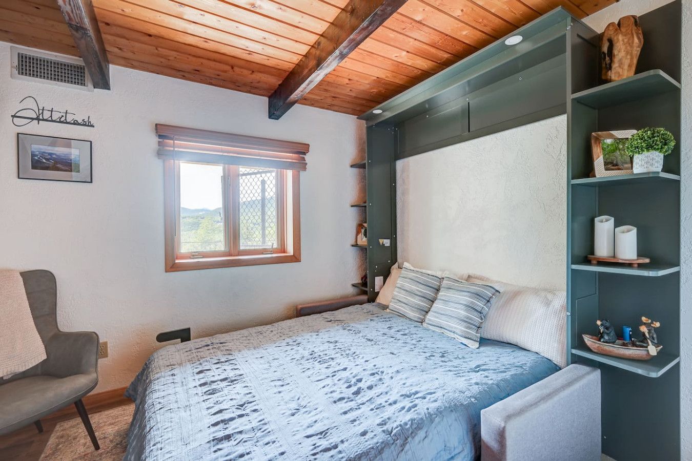 Queen murphy bed that makes as a comfy couch and TV area