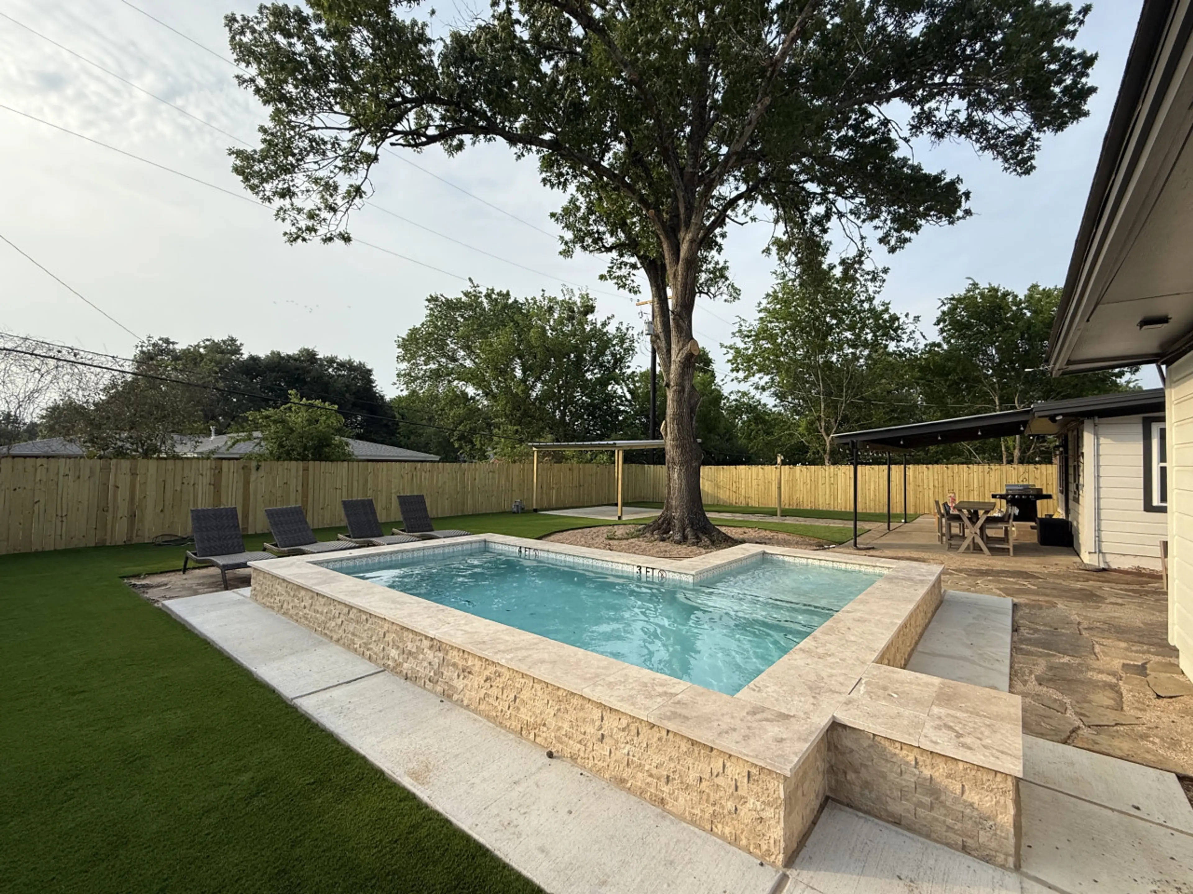 Come hang pool side with Artificially Turfed Backyard and Loungers and Yard Games Galore