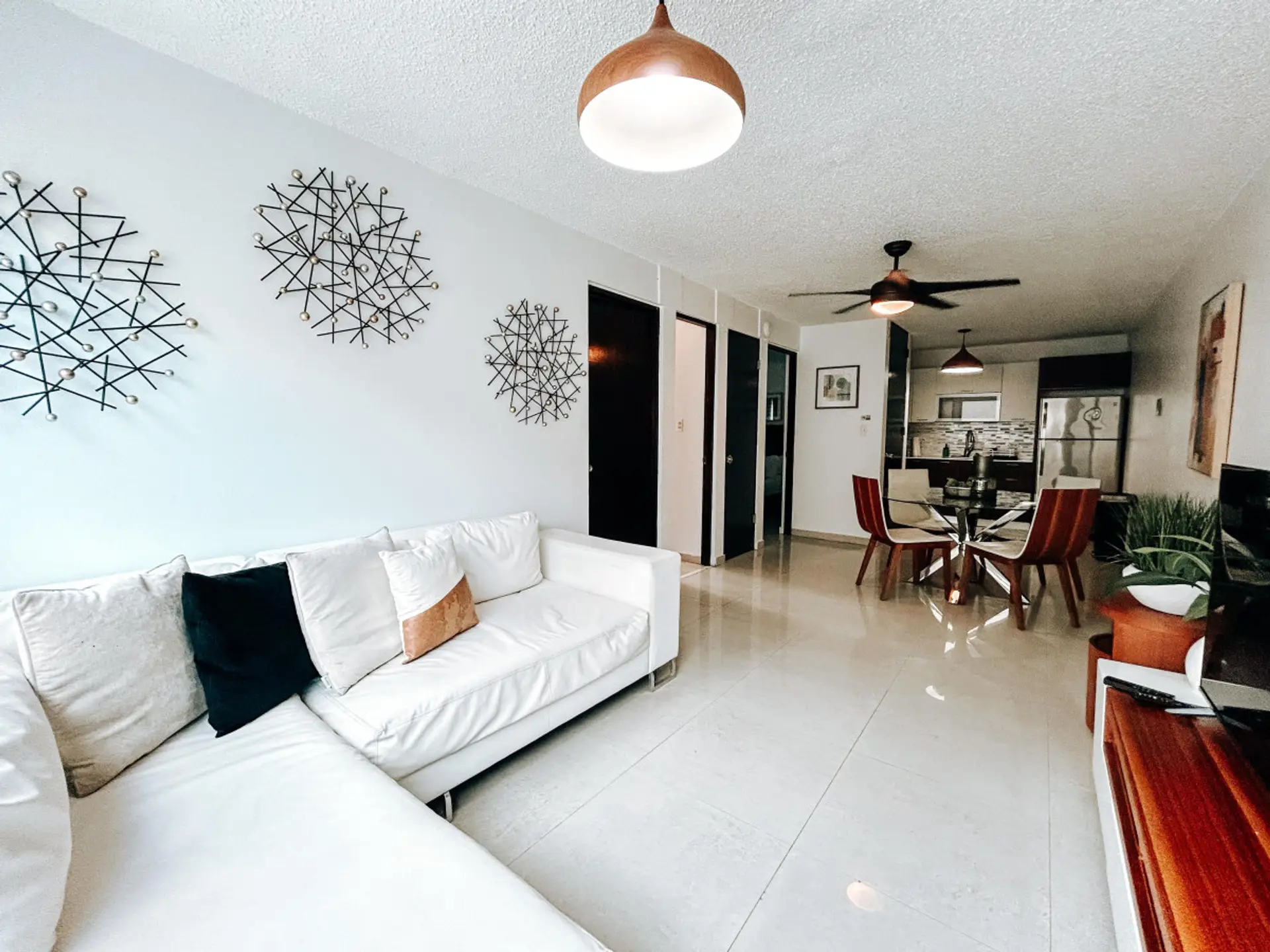 Experience luxury and comfort like never before in our elegantly designed living room, featuring a plush L-shaped sofa perfect for lounging.