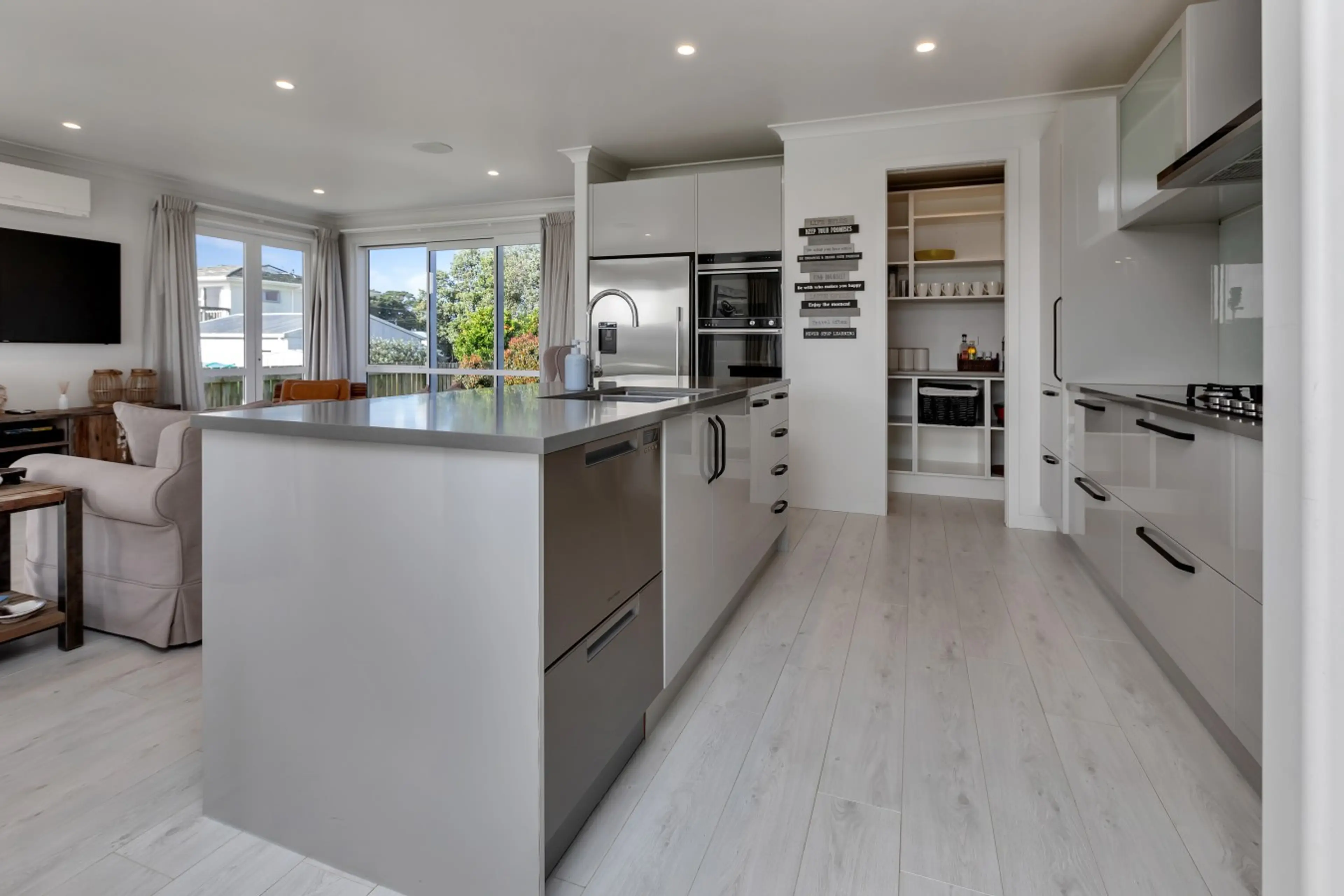 Fully equipped modern kitchen with large island and walk-in pantry