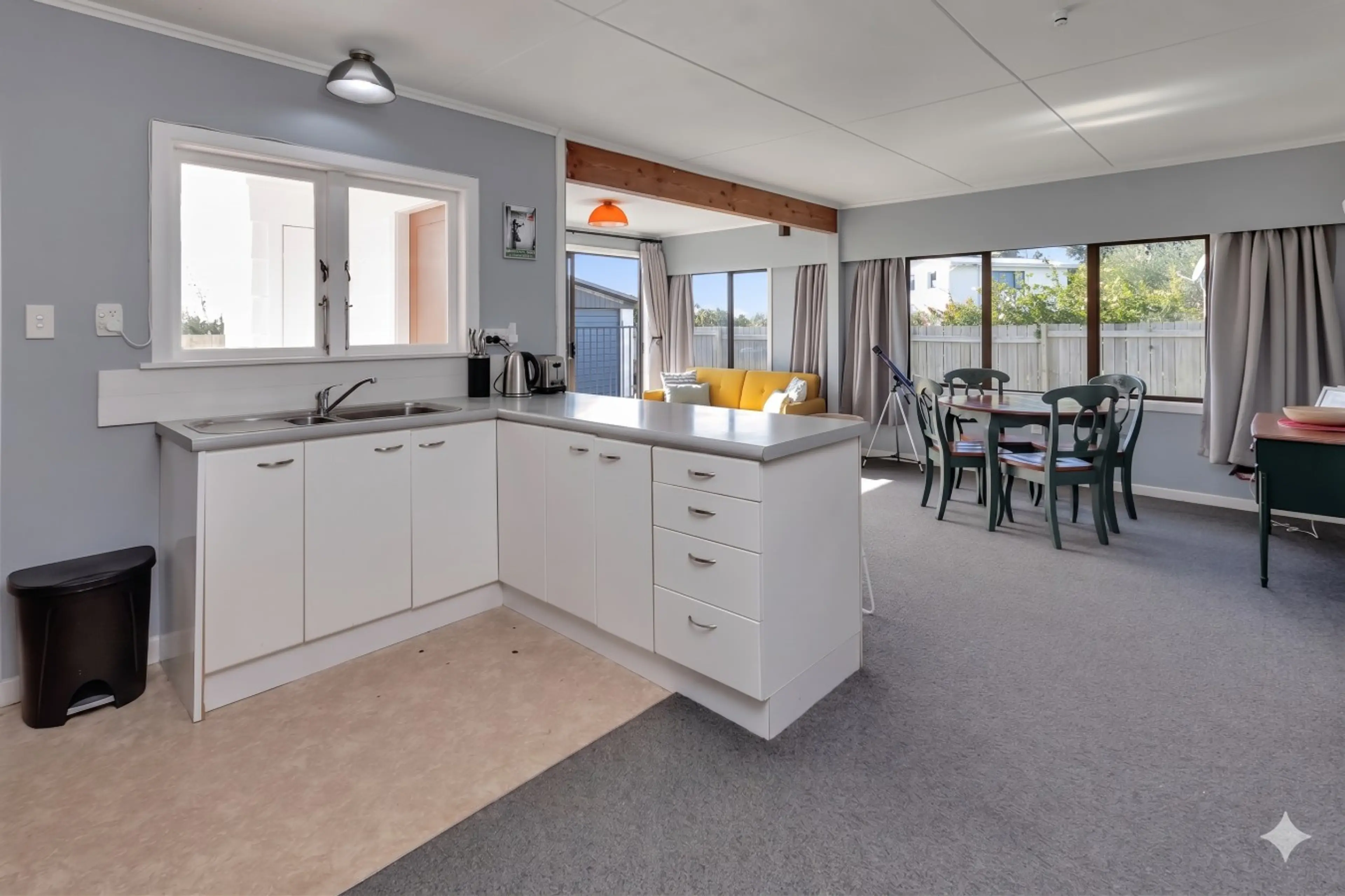 Living space combining kitchen, dining, and lounge.