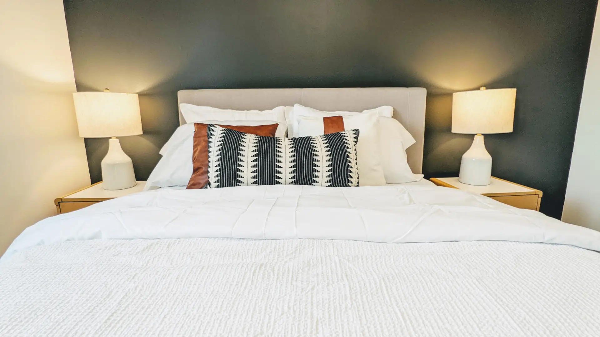 Relax in this private bedroom featuring a comfortable queen-size bed, a dedicated workspace, and a spacious closet for all your storage needs.