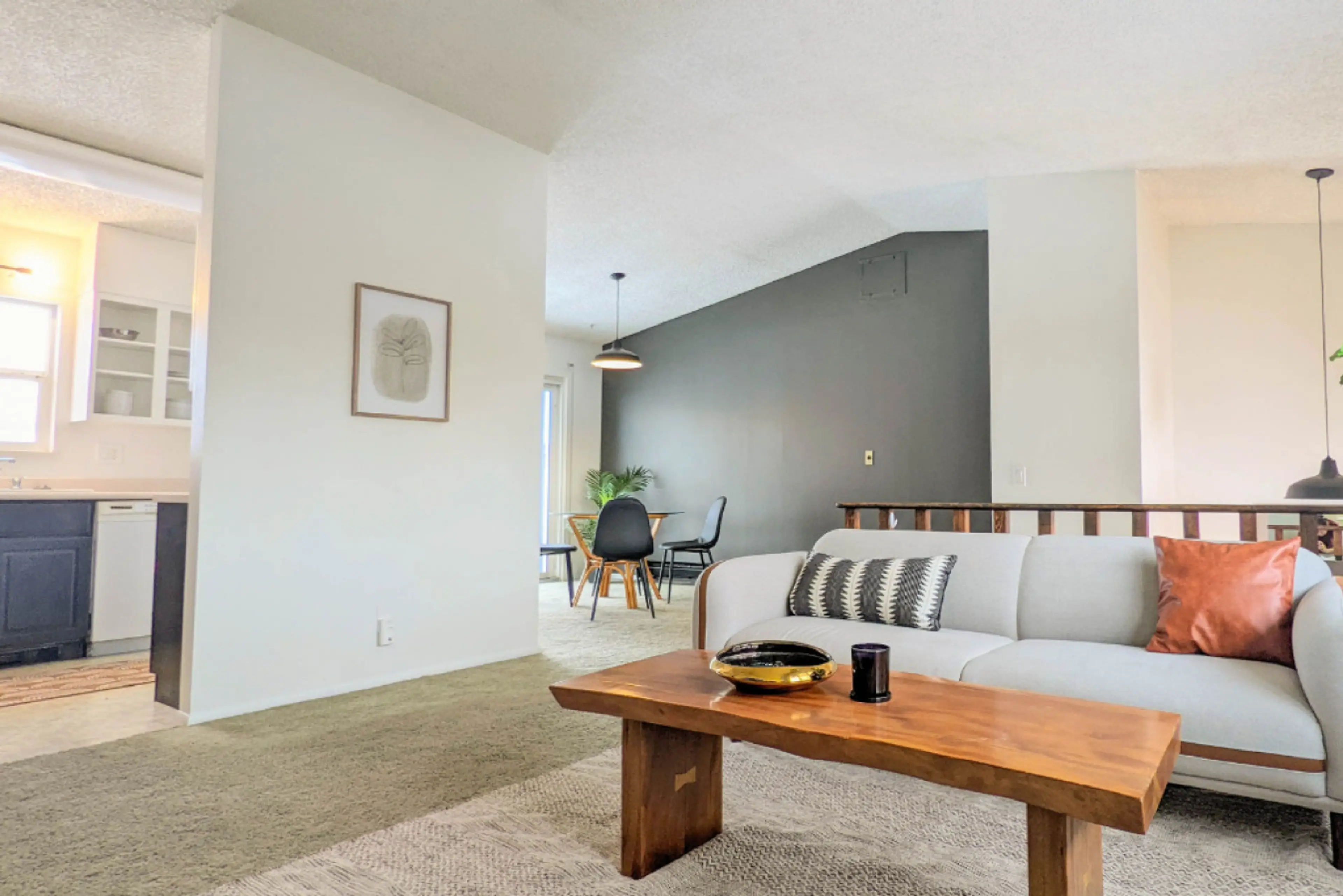 Enjoy the inviting atmosphere of the upper-level living room, featuring a cozy couch, a comfortable armchair, and a TV—perfect for relaxing and unwinding.