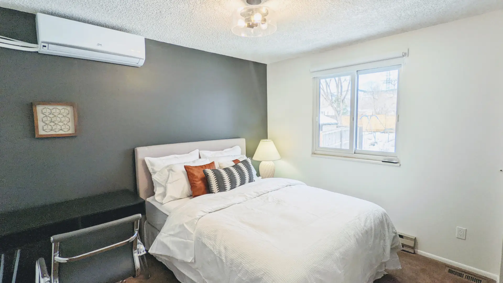 Relax in this private bedroom featuring a comfortable queen-size bed, a dedicated workspace, and a spacious closet for all your storage needs.