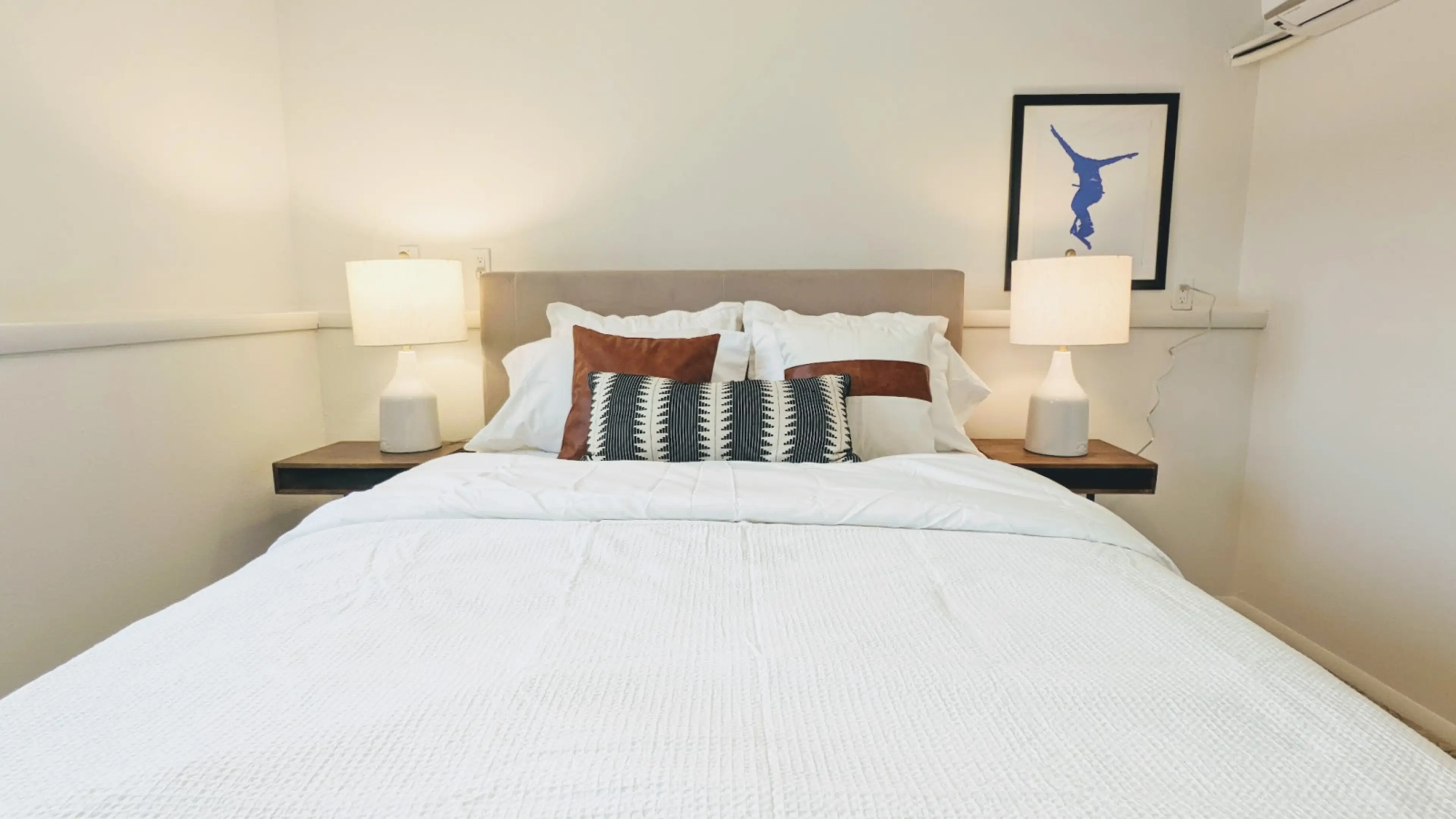 Relax in this private bedroom featuring a comfortable queen-size bed, a dedicated workspace, and a spacious closet for all your storage needs.