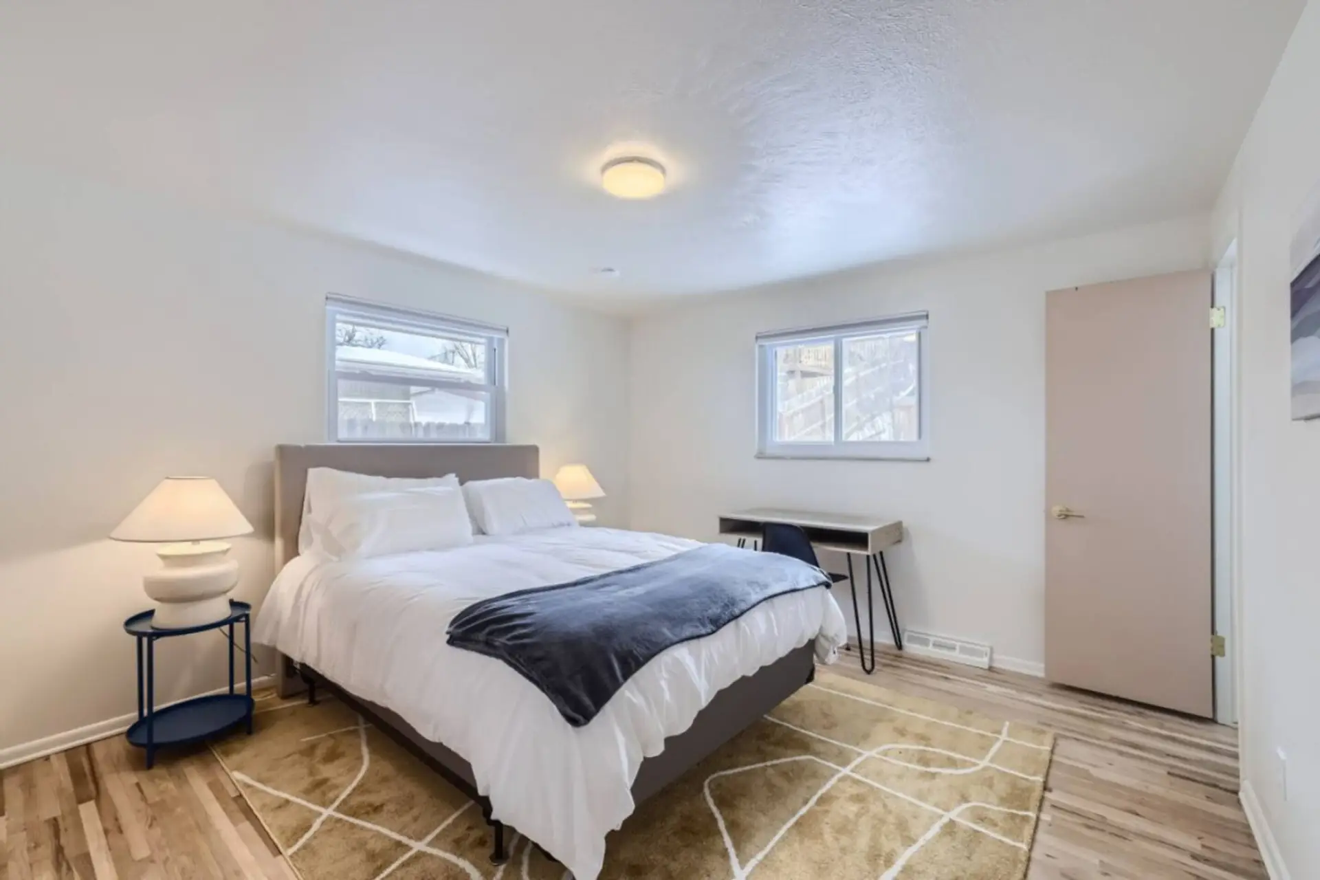 Relax in this private bedroom featuring a comfortable queen-size bed, a dedicated workspace, a spacious closet, and a private ensuite bathroom for your convenience.