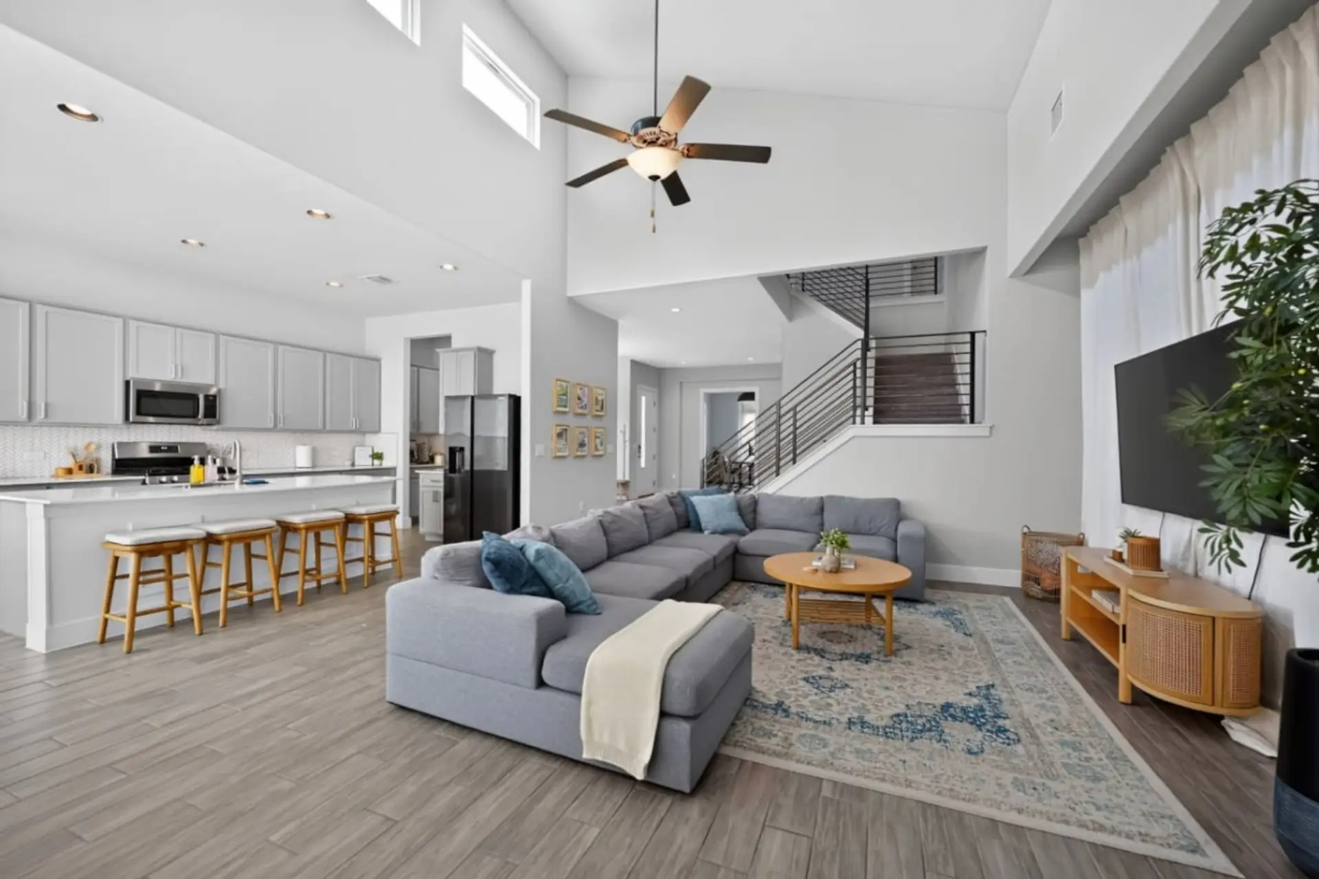Bright living room with vaulted ceilings, a smart TV, and plenty of room for the whole group to relax