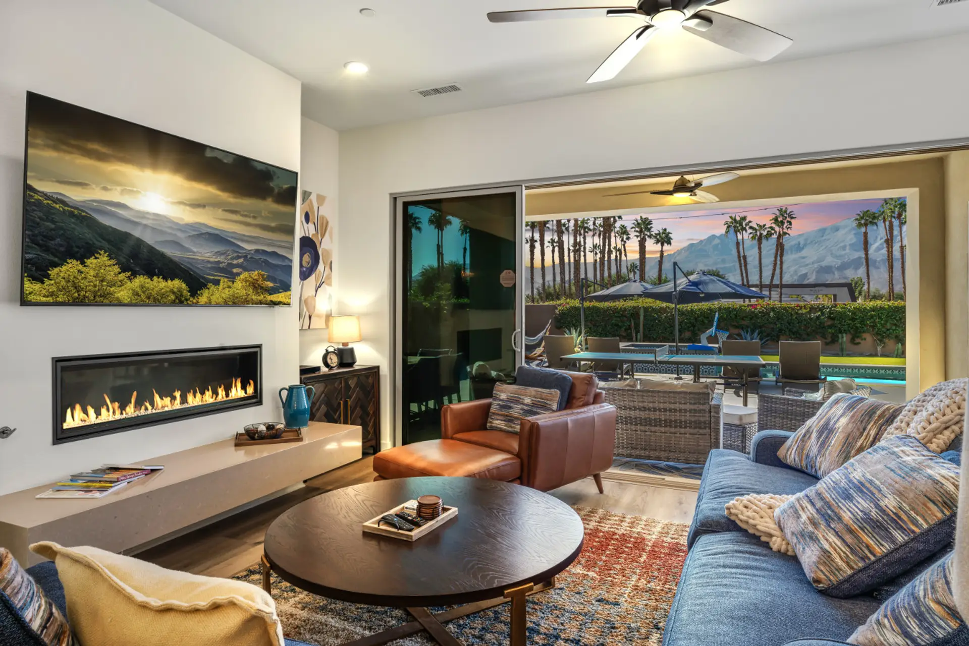 Stylish living room w/ fireplace & plush seating opening to the patio for seamless indoor-outdoor living