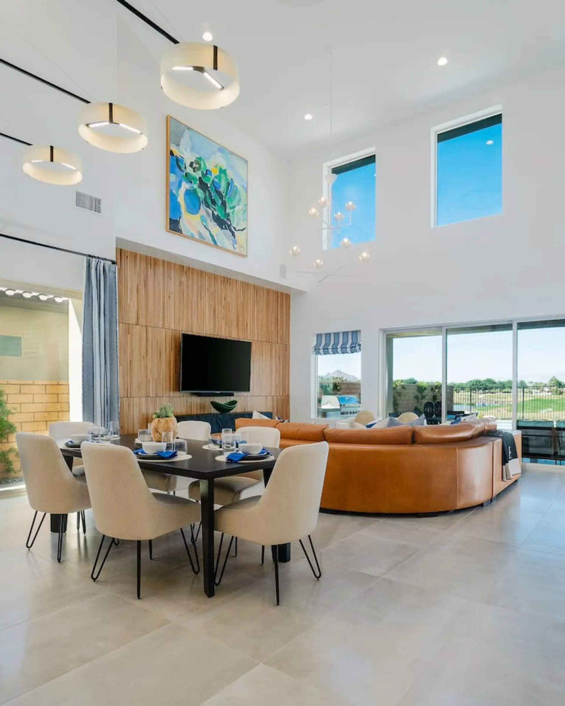 Bright open living space w/ soaring ceilings, plush seating & seamless indoor-outdoor flow