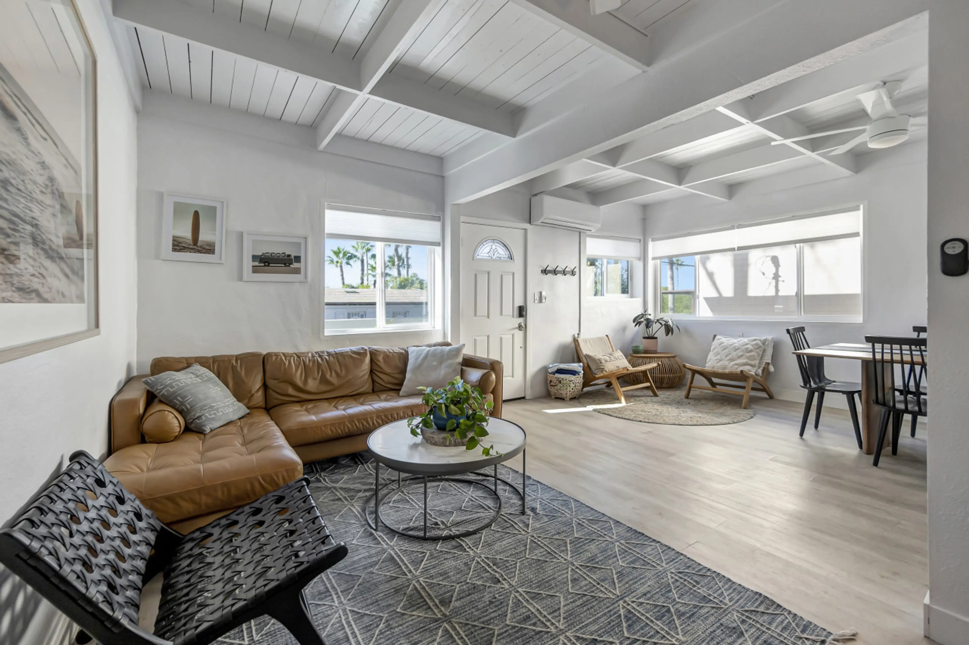 Bright open living space w/ vaulted white-beam ceilings & cozy seating for relaxed gatherings.