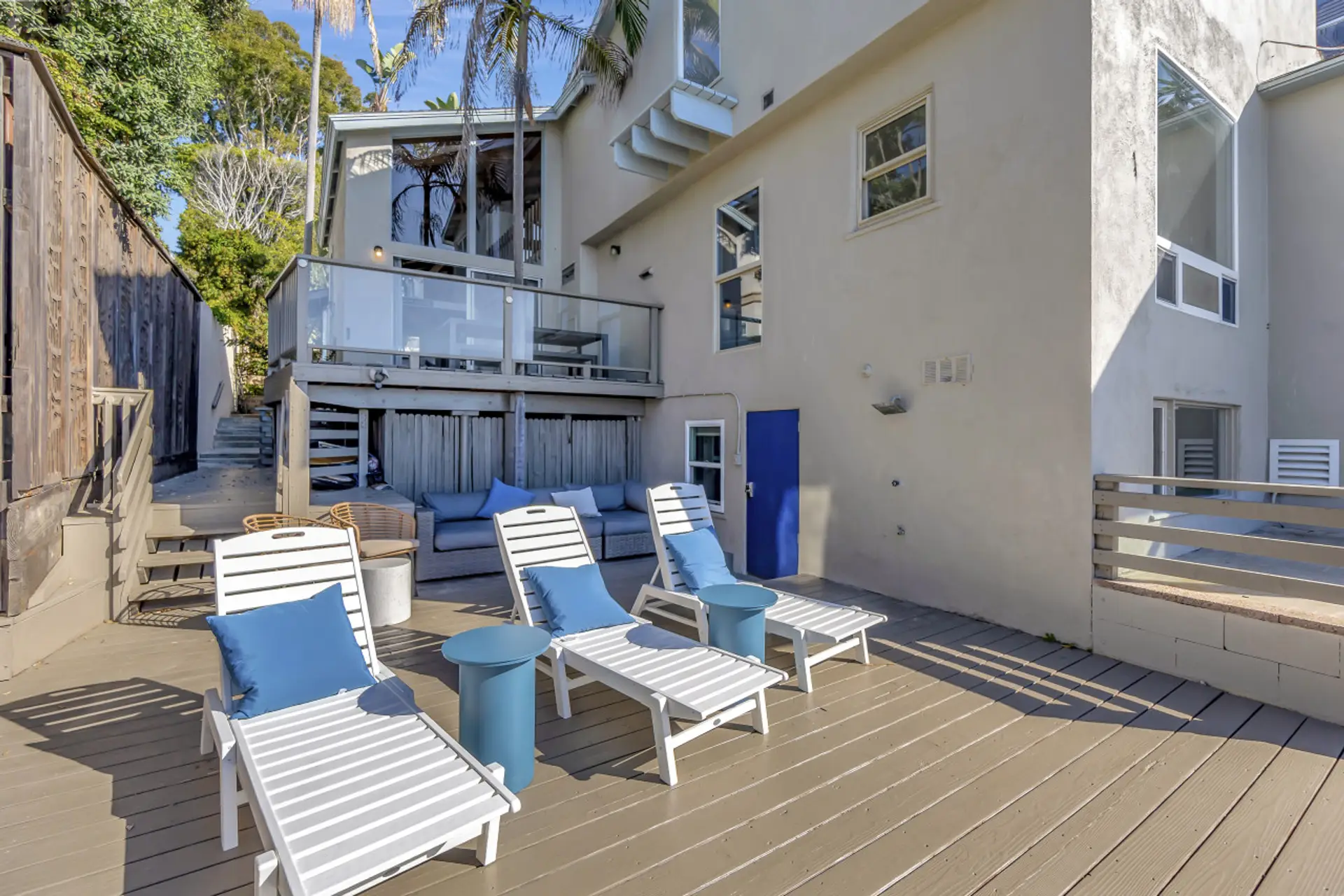 Spacious lower deck w/ lounge chairs & open-air relaxation by the sea.