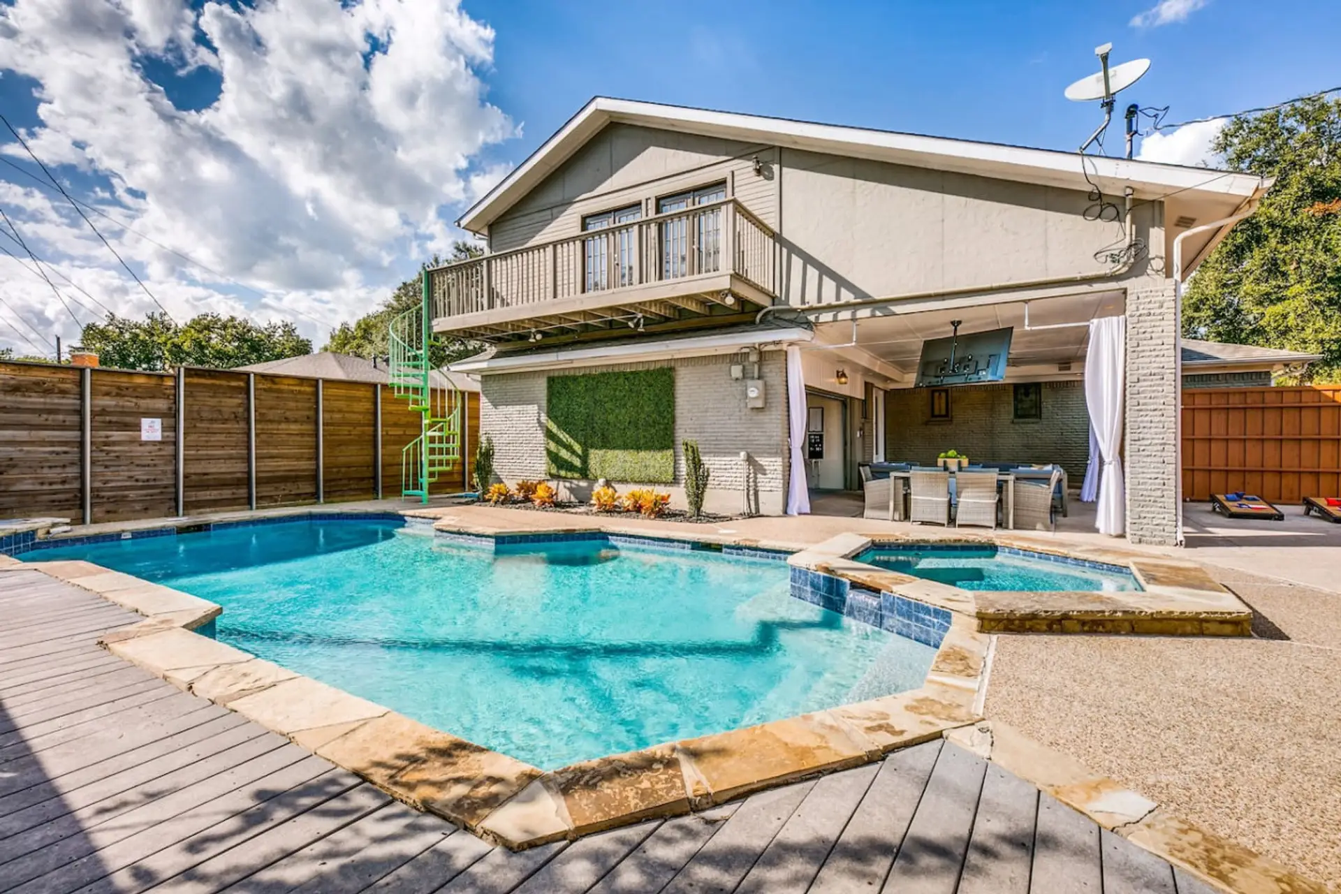 Large, fenced backyard area with a lot of privacy for your group stay! Enjoy the pool, hot tub, and lounging in the sun or shade. Watch TV while you grill, play games, or just enjoy dinner outside on a nice day.