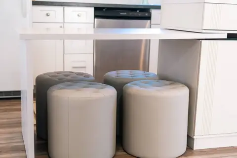 Round upholstered stools under the kitchen island
