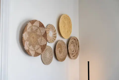 Woven baskets hung on a white wall