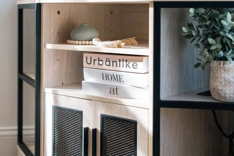 Shelf with a decorative sign, a basket, and a plant