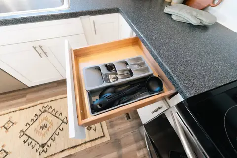 Kitchen drawer with silverware and cooking utensils