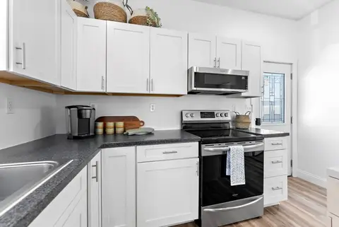 Stainless range, microwave, and coffee maker along the kitchen counter