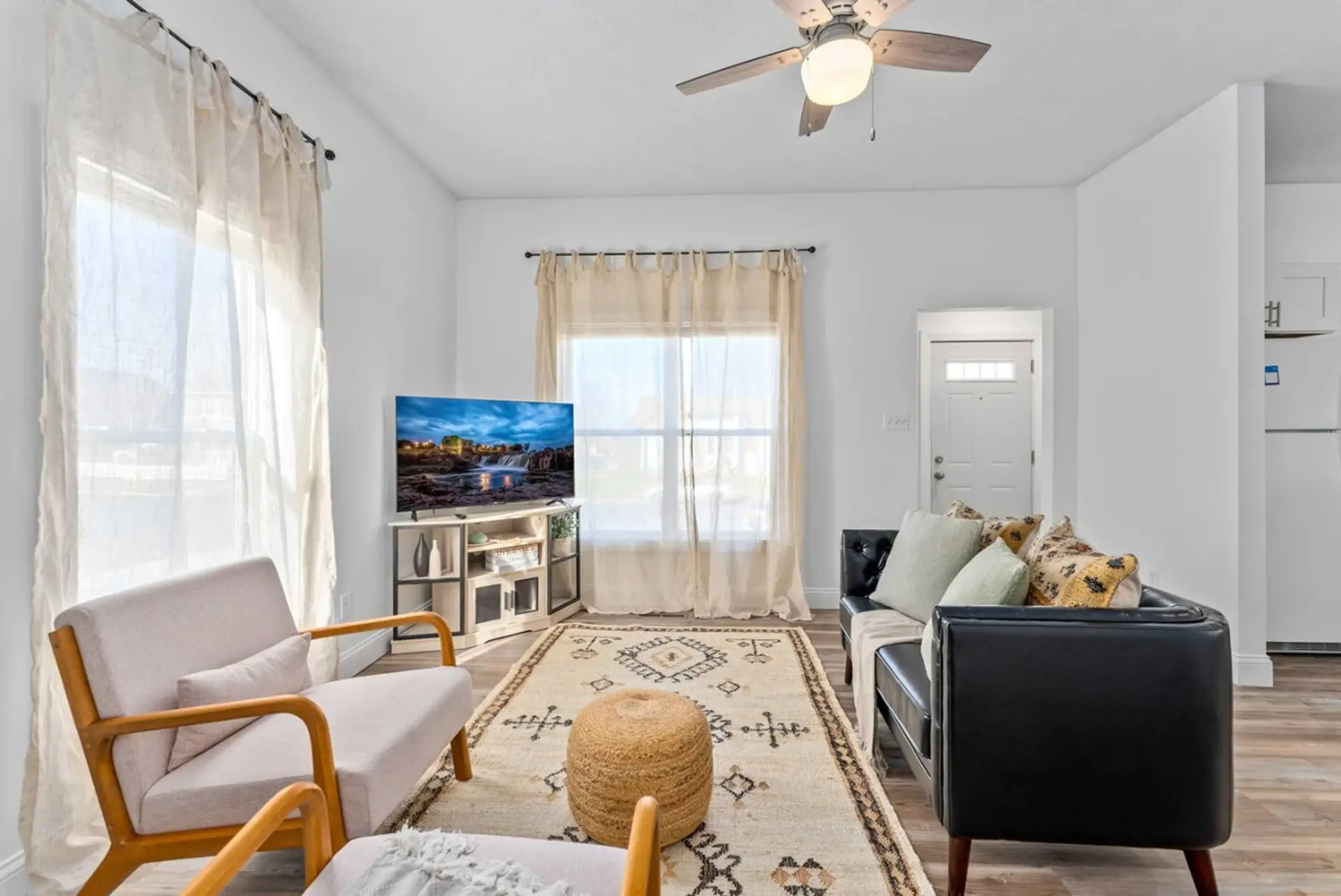 Cozy and bright living room with comfortable seating and a smart TV for your enjoyment.
