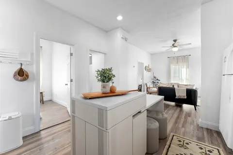 Kitchen island in the foreground, with the living room beyond