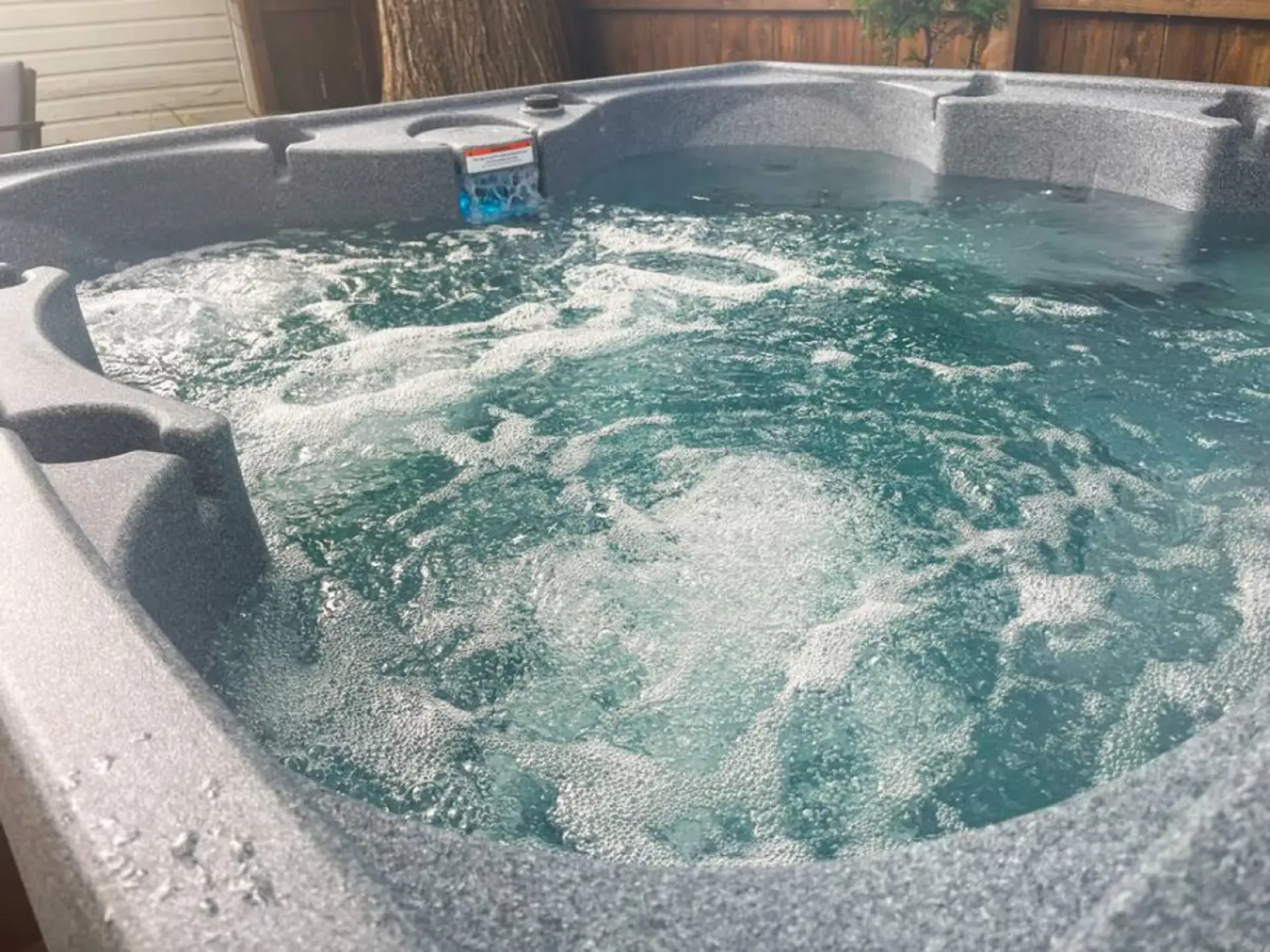 Indulge in relaxation in the shared hot tub outside, offering a serene oasis after a day of exploring. Perfect for unwinding under the stars.