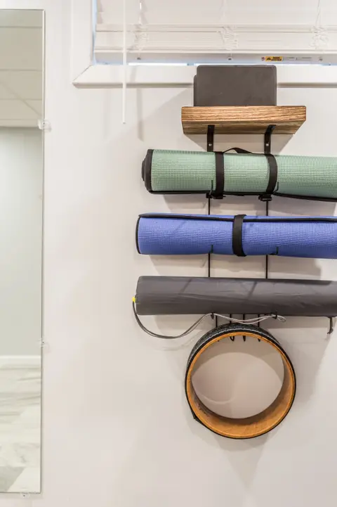 Yoga mats stored on a wall rack