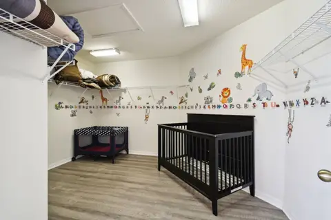Nursery with a crib and animal wall decals
