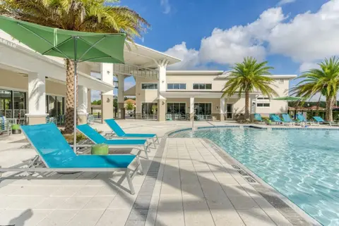 Veranda Palms community pool with loungers and umbrellas, shared with other residents