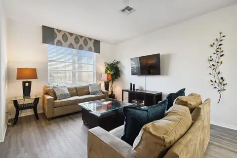 Sofas around a coffee table facing a wall-mounted TV
