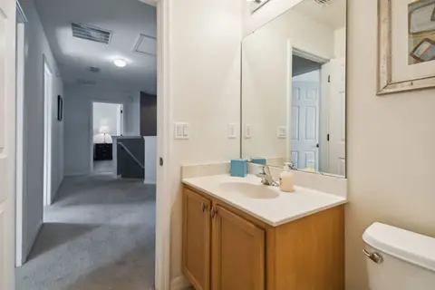 Bathroom vanity next to the upstairs hallway