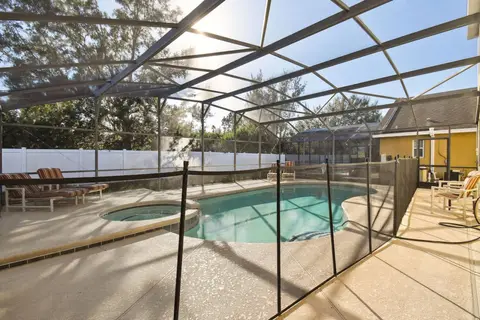 Screened pool and hot tub with a mesh safety fence