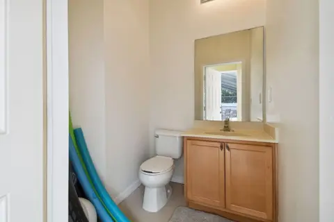 Bathroom by the pool with a toilet and a vanity