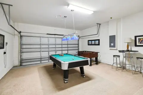 Game room with a pool table, foosball, and bar stools