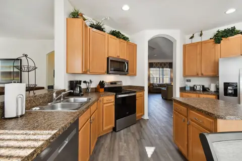 Kitchen counters with a double sink and wood cabinets