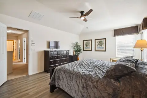 Primary suite with a queen bed, seen from the doorway