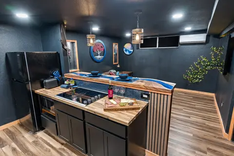 Fantasy-wing kitchen with a cooktop and the blue epoxy river bar