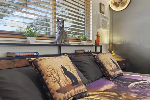 Wolf pillows and a wolf statue on the headboard shelf