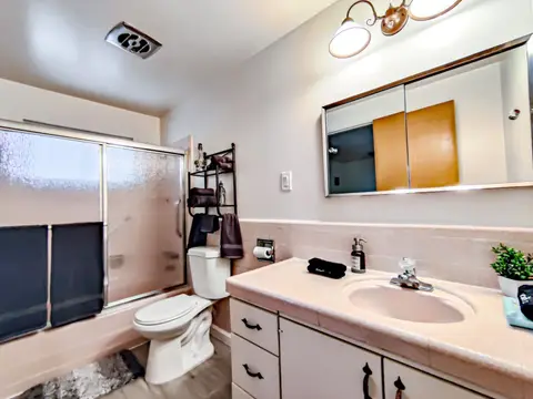 Bathroom with a sliding glass shower door and a single vanity