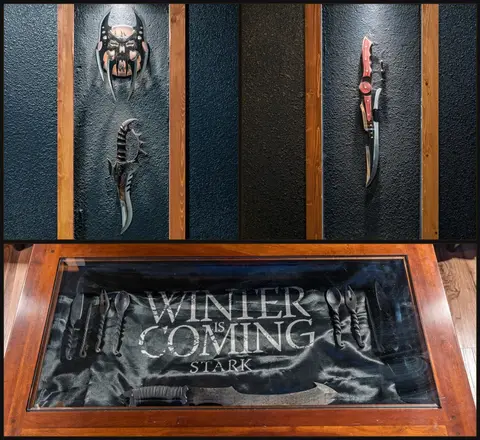 Lit weapon displays above a glass-top coffee table holding a banner