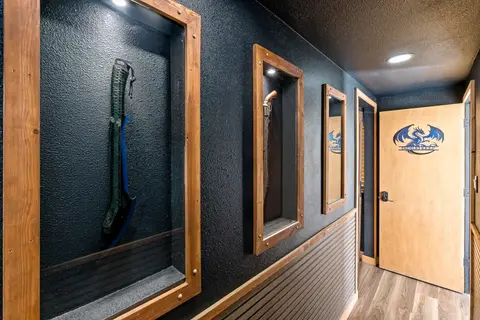 Lit wooden display cases along the hallway to the entrance